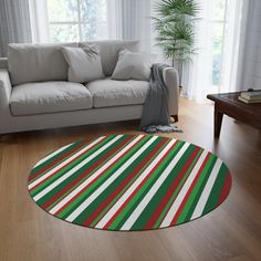 a living room with a white couch and green red and white striped rug on the floor