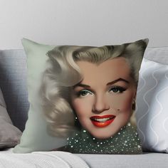 a marilyn monroe throw pillow sitting on top of a couch