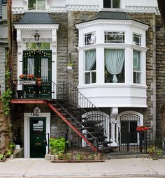 a house with stairs leading up to the front door