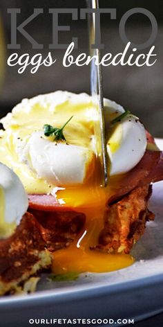 a plate with eggs benedict on it and a knife sticking out of the top one