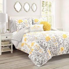 a bed with yellow and gray flowers on it