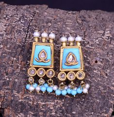 This Earrings is crafted using traditional techniques in 22k Yellow Gold with turquoise pearls and Polki Diamonds. The Turquoise are all natural and have a rough organic look, thus enhancing the rawness and beauty of the piece. Turquoise also known as Firoza has remarkable healing properties and ensure overall physical fitness. It enhances immunity and eliminates pollution inflicted diseases. The Birthstone for December, Turquoise is said to bring good luck, peace and protection. Turquoise is also the 11th wedding anniversary gemstone. Gross Weight: 12.930 gms Dimensions: Length: 36mm Width: 16mm Perfect for any look or occasion!  Packaging and Shipping Your item is packed very carefully to avoid any in-transit damage. We first pack it in a zip pouch and then put it in a Bubble Pouch. Your Elegant Turquoise Kundan Earrings, Turquoise Kundan Earrings For Festivals, Traditional Turquoise Danglers For Gift, Festive Turquoise Kundan Earrings, Festive Kundan Turquoise Earrings, Traditional Turquoise Earrings With Latkans, Turquoise Earrings For Festive Occasions, Festive Turquoise Earrings As Gift, Elegant Turquoise Earrings For Festivals