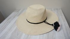 "Beautiful wide brim beige with pink/black tassels and black rope paper raffia hat made in 1990s for German company C&A. The edge of brim is wired to keep its shape. Material: 88% paper raffia, 12% polyester. Size looks like M/S. Total diameter of hat is c. 15'' (38 cm). Width of brim is 4\" (10 cm). Circumference for head is c. 22\" (56 cm). Perfect condition, new old stock. The top is bit battered, but it will go with wear. More hats you can find here: https://www.etsy.com/shop/LivePastVin Adjustable Fringe Fedora Straw Hat, Casual Fedora Hat With Fringe, Casual Adjustable Sun Hat With Fringe, Casual Sun Hat With Fringe, Casual Sun Hat With Fringe And Curved Brim, Casual Hats With Fringe And Curved Brim, Casual Wide Brim Sun Hat With Fringe, Wide Brim Straw Hat, Tassel Decor