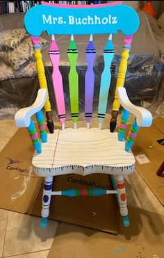 a chair made out of colored crayons with the name mr buchholz on it