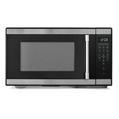 a microwave oven with the door open on an isolated white background, it is black and silver