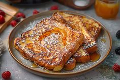 two pieces of french toast on a plate with raspberries