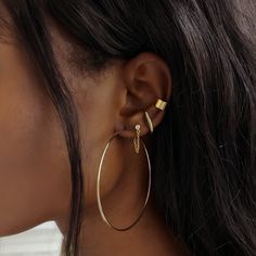 Modern and edgy, these suspender earring is worn like a stud earring but it appears to hug your whole ear lobes. Can be worn on second hole for those with larger ear lobes. Gold Vermeil Hypoallergenic, lead and nickel free Inside Length: 16mm(first hole) or 13mm(second hole)) Thickness: 1.6mm Comes with butterfly earring backs #E569-G Earing Aesthetic, Gold Earring Cuff, Large Gold Hoop Earrings, Suspender Earrings, Set Ideas, Moms Bracelet, Choker Pendant, Studded Necklace, Gold Statement Ring