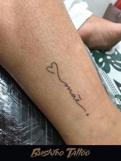 a person with a tattoo on their leg that says, love is in the air