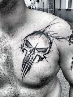 a man's chest with a black and white tattoo design on the chest area