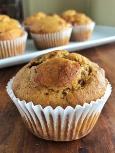 muffins sitting on top of a wooden table