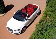 an overhead view of a white convertible car with red seats