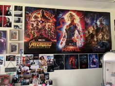 the avengers movie poster is hanging on the wall in front of pictures and posters above it