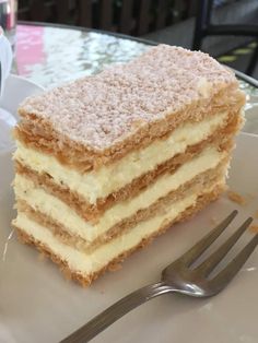 a piece of cake sitting on top of a white plate with a fork next to it