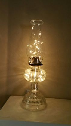 a lamp that is sitting on top of a table with some lights in the shape of a teapot