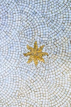 an artistic mosaic design with a yellow star on it