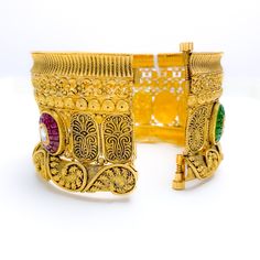 PRODUCT DETAILS Gold Purity(karat): 22k Item Weight(grams): 61.5 Item Finish: Oxidized Stone: Kundan Bangle Size: 2.5 Bangle Opening(diameter): ﻿2.3" Openable: Yes - Screw w/ Hinge Number Of Pieces: 1 Bangle Ceremonial Fusion Bangle With Hand Set Details, Fusion Style Ceremonial Bangle Bracelets, Ceremonial Fusion Bangle With Hand Set, Fusion Style Openable Bracelets For Festivals, Fusion Style Bracelets For Puja And Diwali, Festive Fusion Style Ceremonial Bangle, Fusion Style Bangle Bracelet With Intricate Design, Gold Jeweled Cuff Bracelet Bangle, Gold Cuff Bracelet With Intricate Design For Festive Occasions