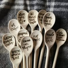 six wooden spoons with writing on them