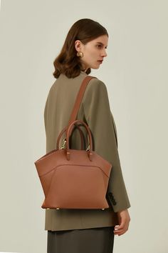 European Elegance in Every Stitch: Your Go-to Winged Tote Unveiling our chic European winged tote handbag, meticulously crafted from superior calfskin leather, exuding timeless pure color aesthetics. The handy zip closure coupled with modern stitch detailing seamlessly marries convenience with vogue. Available in versatile shades of brown, khaki, green, and black, its interior is thoughtfully designed with card slots, a zipper pocket, and a main compartment, ensuring your belongings are organize European Elegance, Just Style, European Design, Shades Of Brown, European Designs, Tote Handbag, Green And Black, Leather Care, Khaki Green