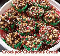 a white bowl filled with lots of chocolate covered christmas cracker bites on top of a table