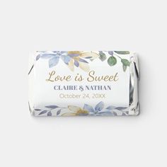 a bar of soap with blue and white flowers on it, the label says love is sweet