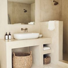 a bathroom with a sink, mirror and towel rack on the wall next to it