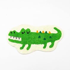 a green rug with an alligator on it