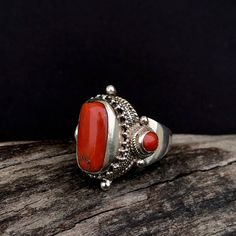 Unveil the allure of our Tibetan Coral Ring - a masterpiece of cultural elegance. Crafted with precision, this ring features genuine coral, echoing the vibrancy of Tibetan traditions. The intricate silverwork showcases timeless craftsmanship, making it a wearable work of art. Elevate your style with the rich heritage of Tibet embodied in this unique Tibetan Coral Ring. Make a statement that transcends trends and embraces the beauty of tradition.  Center coral measures approximately;  17mm X 10mm Red Coral Ring, Tibetan Ring, Saddle Ring, Gold Dragon, Coral Ring, Thumb Rings, Wrap Rings, The Ring, Red Coral