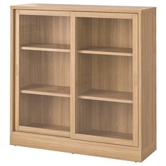 a wooden bookcase with three shelves on one side and two doors on the other