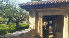 the entrance to an old building with stone walls