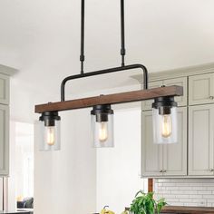 a kitchen island with two hanging lights over it