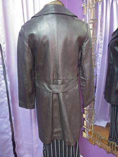 "Great vintage long jacket in a rich dark mocha brown. No labels. This is in good vintage condition with minor wear, lining is unstained and there is no damage... but there are marks indicating that three decorative buttons are missing (see pictures.) Three button closure, false belt across the back, fully lined, no shoulder pads, Measurements are approximately 32\" long, 23\" sleeves, 16.75\" back shoulders, fits like a 6/8. We want you to buy with confidence, please contact us with any questio Brown Long Outerwear With Button Closure, Long Brown Outerwear With Button Closure, Brown Formal Outerwear With Buttons, Classic Long Brown Outerwear, Formal Long Brown Outerwear, Classic Vintage Brown Outerwear With Buttons, Vintage Long Leather Jacket For Business, Leather Long Jacket, Mocha Brown