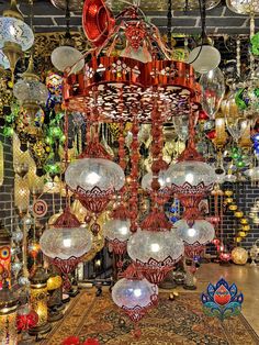 a room filled with lots of different colored lights and hanging decorations on the ceiling above it