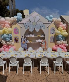 a table set up for a baby's first birthday party with balloons and decorations