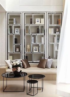 a living room filled with furniture and bookshelves