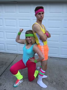 two people dressed up in costumes posing for the camera with their arms around each other