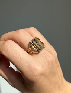 "* Antique circa 1930's 10 carat yellow gold ring, set with a hand carved tiger's eye cameo, depicting two Roman soldiers.  * Stamped \"B10K\" on the inside of the band.  * Face of the ring measures at 0.7 inch long, and 0.6 inch wide.    Band Width- 3.3 millimeters  * Weight- 5.9 grams Please view and inspect the photos closely, as they are considered part of the condition. I endeavor to fully disclose all condition information clearly, however, please note that what qualifies as excellent cond Classic 14k Gold Brown Ring, Classic Brown Signet Ring For Anniversary, Brown Gemstone Rings In 14k Gold, Antique Brown Rings For Anniversary, Antique Brown Carved Jewelry, Brown Polished Finish Signet Ring For Anniversary, Brown Polished Signet Ring For Anniversary, Classic Brown Hallmarked Rings, Antique Brown Ring Jewelry