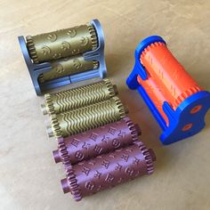 three different colored rollers sitting on top of a table