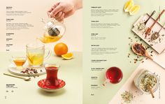 a menu with oranges, tea and other food items on the table next to it