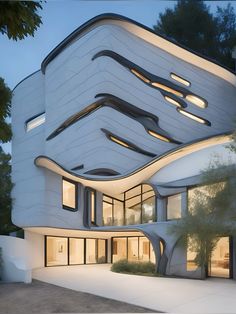 an architecturally designed white building with lots of windows and lights on the side of it