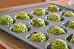 a muffin tin filled with cupcakes covered in pesto