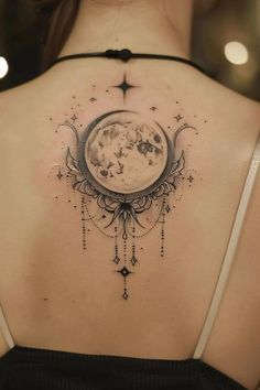 the back of a woman's shoulder with a moon and stars on it