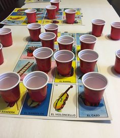 red cups are lined up on a table with matching cards and numbers to match them