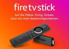 the amazon fire tv stick is sitting on top of another remote, and it's in front of an orange background