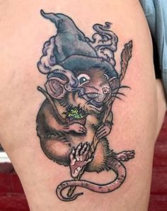 a rat with a witches hat on it's head is holding a snake in its paws