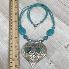 "66.1 Grams, 21\" Long, 2.8\"x2.5\"x0.5\" Pendant, Fashion Turkmen Necklace Beaded Turquoise Inlay (Synthetic) ATS Statement Bohemian, eBN01 Weight: About 66.1 Grams or so Length: About 21\" or so Bottom Pendant Length: About 2.8\" Bottom Pendant Width: About 2.5\" Bottom Pendant Thickness: About 0.5\" Buyer will receive the exact item pictured. Look at images carefully before purchase! Actual item may differ slightly than the image due to image quality, lightening, Contrasts, resolutions, and o Bohemian Blue Beaded Necklaces With Large Pendant, Bohemian Blue Beaded Necklace With Large Pendant, Blue Bohemian Beaded Necklace With Large Pendant, Bohemian Turquoise Beaded Necklace With Large Pendant, Turquoise Bohemian Beaded Necklace With Large Pendant, Nickel Free Blue Turquoise Necklace For Festival, Nickel-free Blue Turquoise Necklace For Festival, Afghan Jewelry, Lake Elsinore