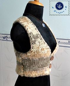 a mannequin wearing a knitted vest with buttons on the front and back