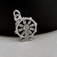 "This Ferris Wheel Charm comes with a silver jump-ring as pictured. Please note that photo is not to scale and may appear larger to show detail. Refer to exact measurements below. Additional attachments (lobster clasp, large-hole bead, necklace chains) are available from the charm-attachments drop-down menu.  For a visual example of the different attachments and what each one is best suited for, scroll through the photos until you see the example photo or visit https://etsy.me/2BY7DAW for detailed information.    { DETAILS } ★ Material: Pewter  ★ Finish Color: Silver  ★ Measurements: 5/8\" x 3/4\" ★ Dimensions: Double-sided { SIMILAR ITEMS }  More carnival themed items available from my shop: https://www.etsy.com/shop/treasuredcharms/search?search_query=carnival { GIFT OPTIONS} Gift boxes Nickel-free Silver Novelty Charms, Novelty Personalized Silver Charms, Novelty Sterling Silver Charm Jewelry, Novelty Sterling Silver Jewelry With Charms, Adjustable Nickel-free Round Pendant Charms, Nickel Free Adjustable Round Pendant Charms, Silver Novelty Charm Bracelet Gift, Silver Novelty Charm Bracelet As A Gift, Novelty Silver Charm Bracelet Gift