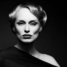 a black and white photo of a woman with blonde hair, wearing an evening dress