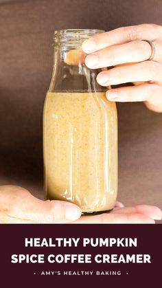 a person holding a glass jar filled with coffee creamer and text overlay reads healthy pumpkin spice coffee creamer