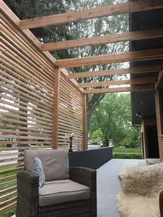 an outdoor patio with wooden slats and furniture